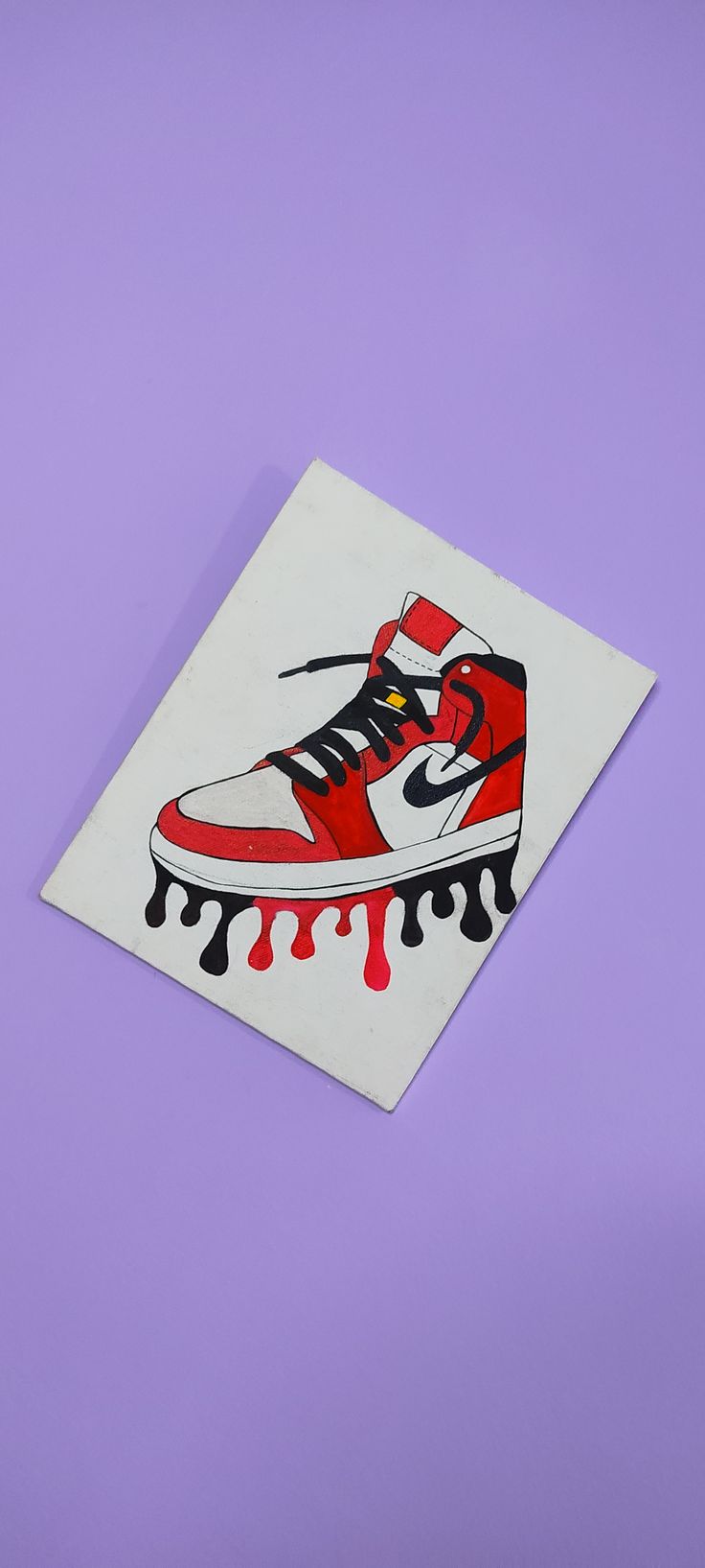 a pair of red and white sneakers on a purple background