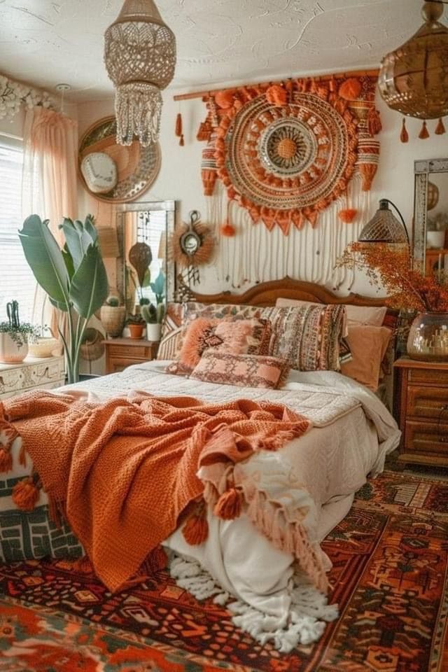 a bedroom decorated in orange and white with lots of hanging decorations on the wall above the bed