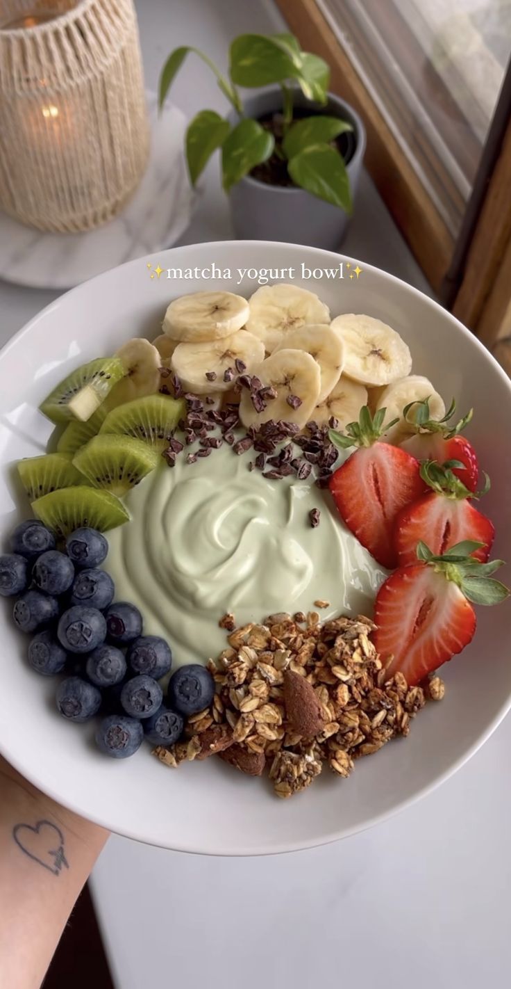 a white plate topped with fruit and yogurt