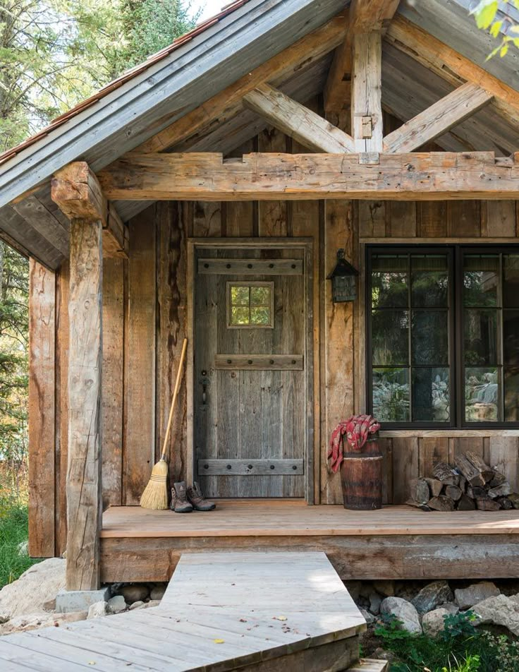 the front porch of a rustic log cabin