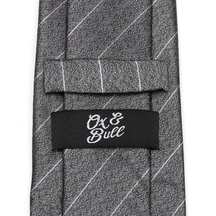 A fashion forward design for classic and modern gentleman alike, this tie strikes the right balance of traditional and contemporary. Blending a rich gray thread with a lighter shade pinstripe, this tie will maintain its shape and hold a perfect knot thanks to the durable yet soft 100% Silk. A versatile tie that can be dressed up with a suit or keep it casual with jeans and a blazer. Classic Gray Tie For Black Tie Events, Fitted Pinstripe Ties For Business, Classic Gray Standard Tie And Suit Accessories, Classic Gray Tie For Semi-formal Occasions, Classic Silver Tie For Business, Gray Ties For Business, Business Pinstripe Standard Tie, Pinstripe Business Tie, Gray Business Ties