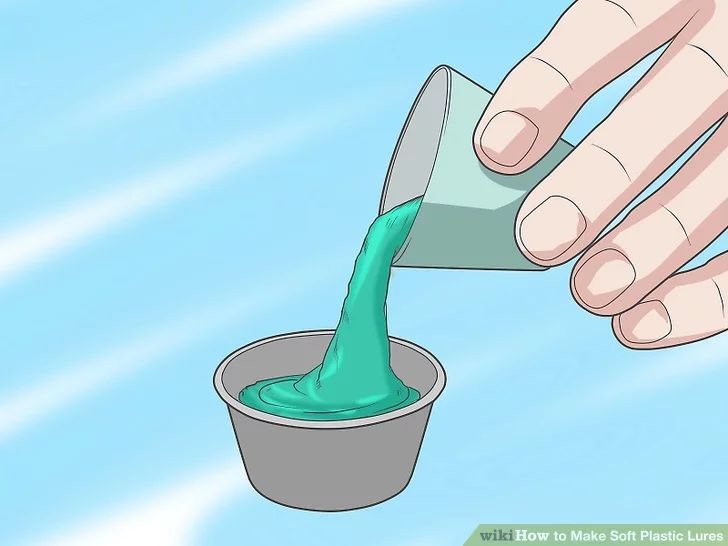 a person pouring green liquid into a cup with the lid down and their hand reaching for it