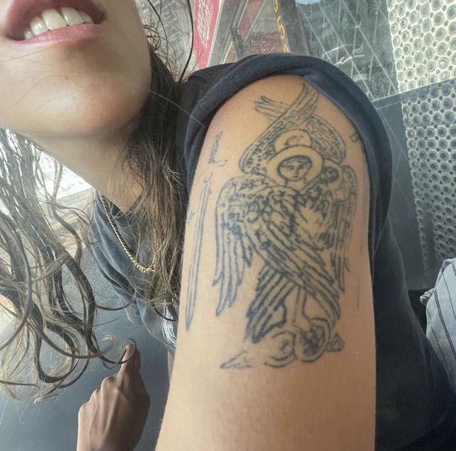 a woman with a tattoo on her arm