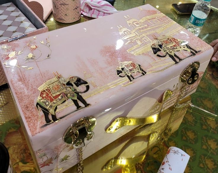 an elaborately decorated trunk sitting on top of a table