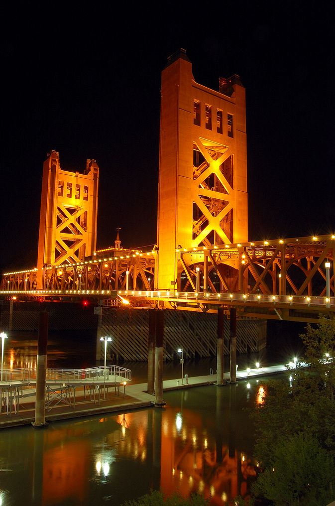 a bridge that has some lights on it and is lit up in the night time