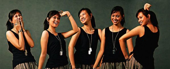 four young women are posing for the camera with their hands on their hipss and smiling