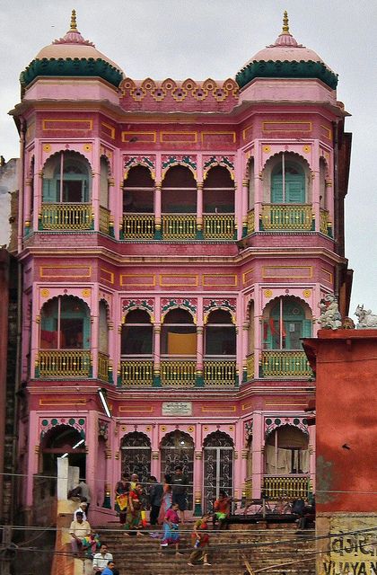 an old pink building with many balconies