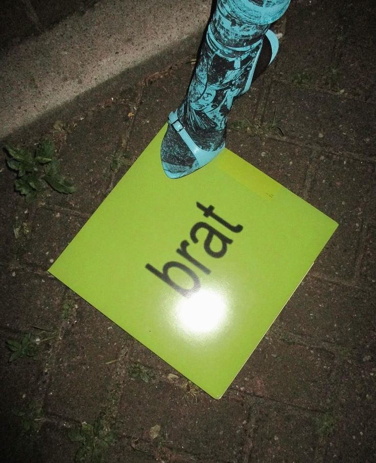 a person standing on top of a yellow sign