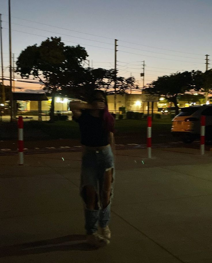 a man riding a skateboard across a parking lot