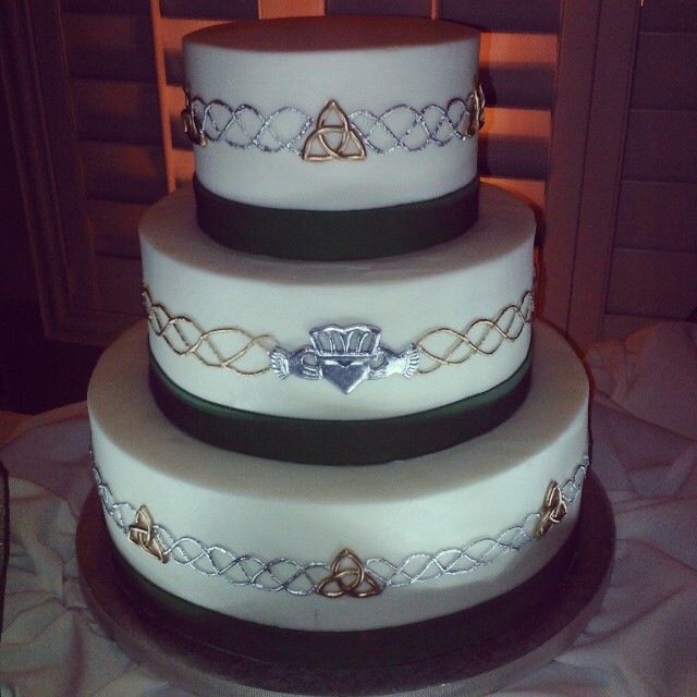 three tiered wedding cake with celtic designs on it