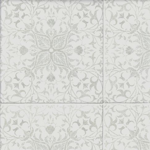 a white tile wall with an intricate design