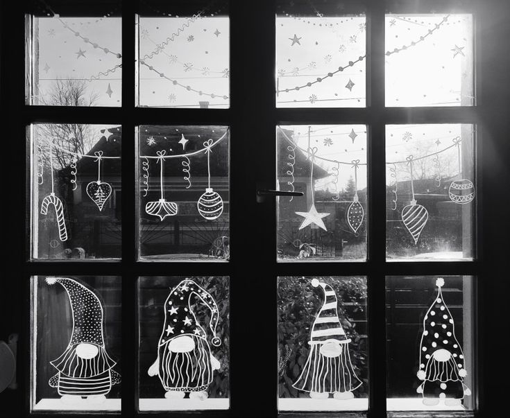 black and white photograph of christmas decorations through a window