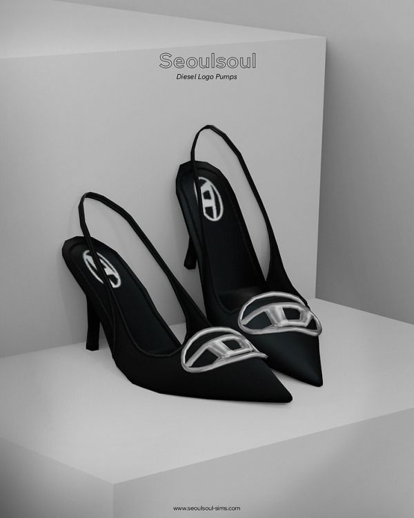 a pair of black high heeled shoes sitting on top of a white box