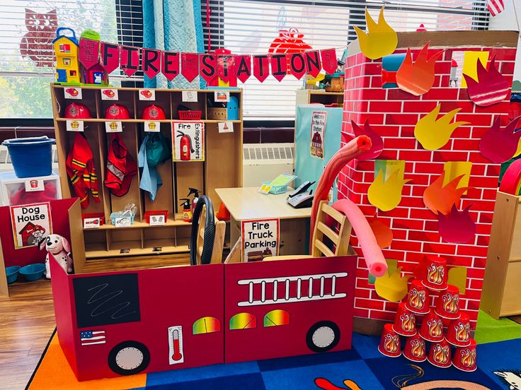 a firetruck made out of cardboard sitting on top of a blue rug