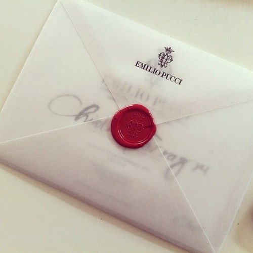 an envelope with a wax stamp on it and a red wax seal in the middle