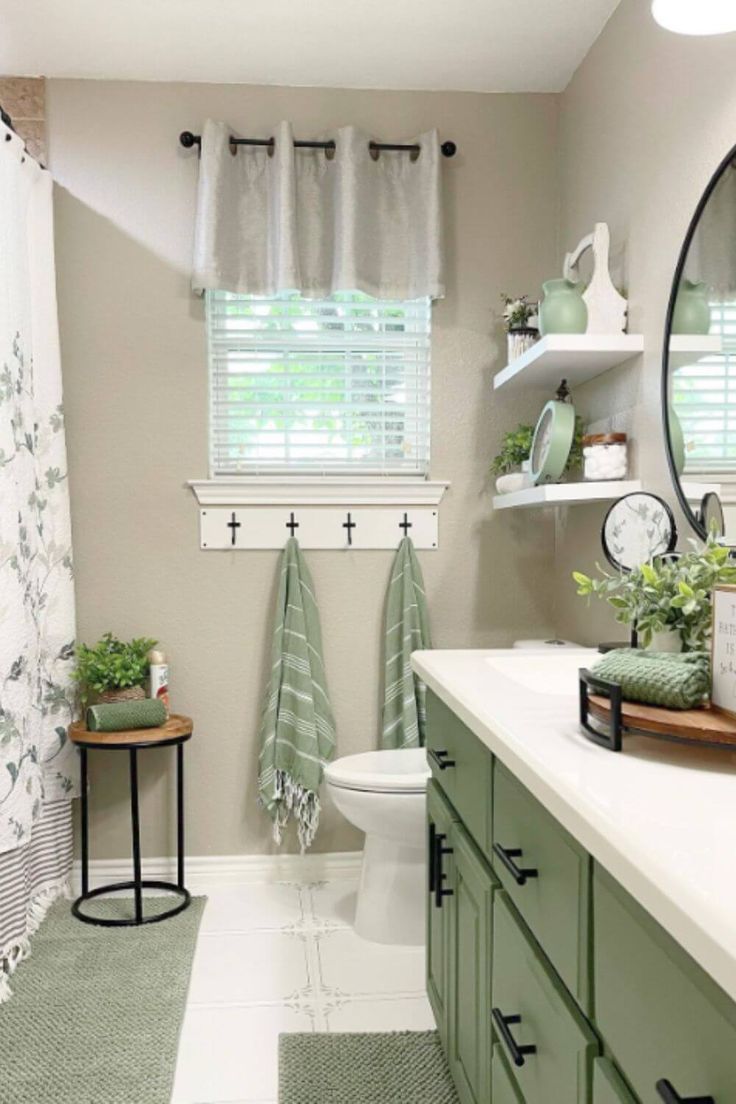 a bathroom with green and white decor in it