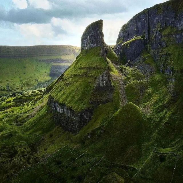 a large green mountain covered in lush green grass