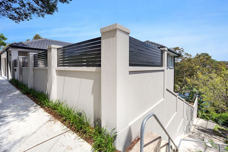 a house with white walls and metal railings