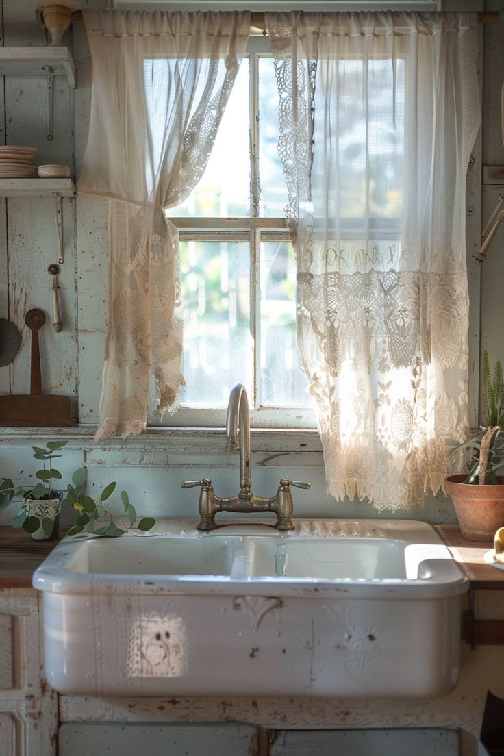 an old kitchen sink in front of a window with lace curtains and potted plants