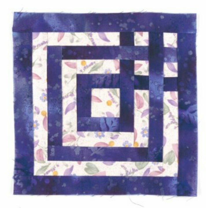 a purple and white quilted square with an interlocking design on it's center