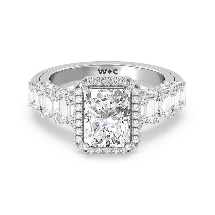 a white diamond ring with baguetts on the sides