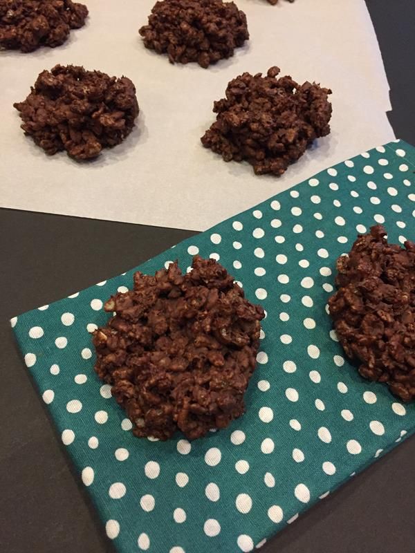 chocolate cookies sitting on top of a blue and white napkin