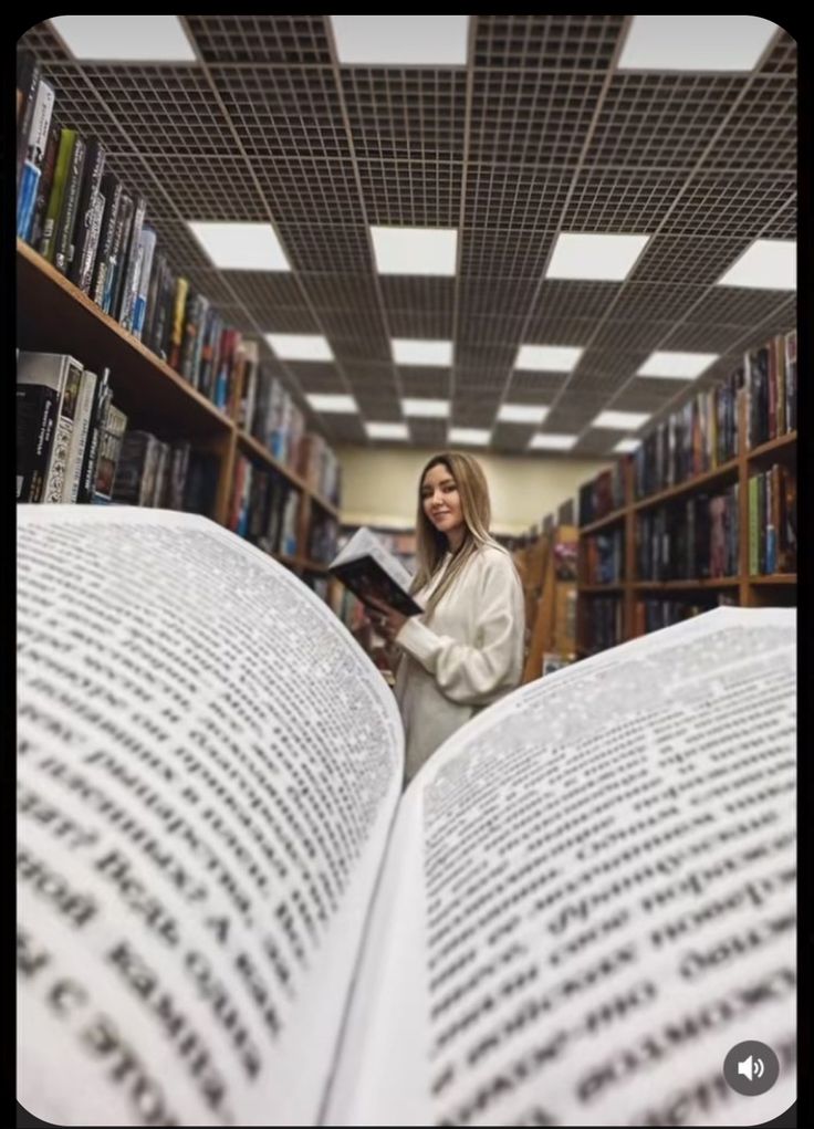 a woman reading a book in a library