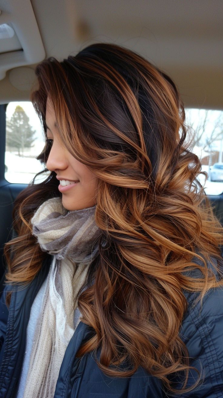 a woman sitting in the back seat of a car wearing a scarf and looking off into the distance