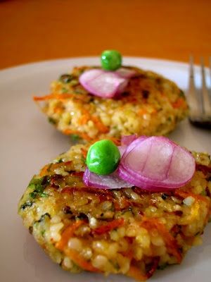 two crab cakes on a plate with a fork