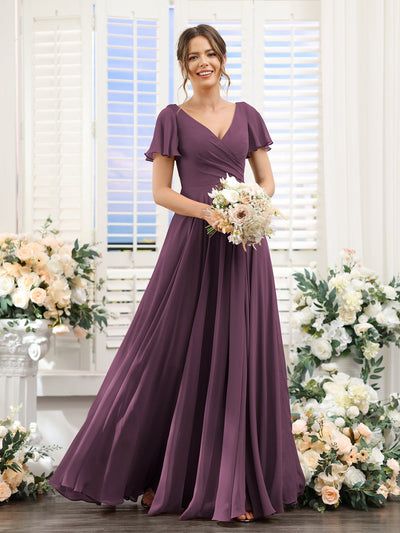 a woman in a long purple dress holding a bouquet