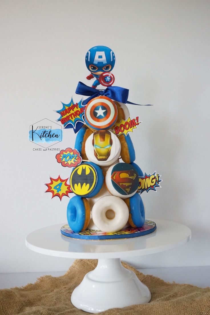 the cake is decorated with superheros and captain america emblems on it's sides