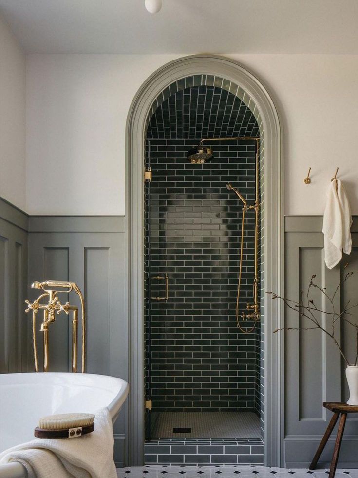 a white bath tub sitting next to a walk in shower