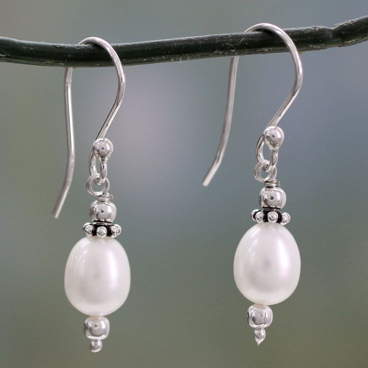 Iridescent pearls, the birthstones of June, shimmer with elegance in this beautiful, classic design. Sterling silver accents offer a harmonious contrast in earrings by India's Narayani. Sterling silver and cultured freshwater pearl Pearl Dangle Earrings, Freshwater Pearls Earrings, Pearl Earrings Dangle, Handcrafted Earrings, Silver Accents, Jewelry Creation, Handmade Sterling Silver, Pearl Drop, Hook Earrings