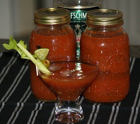 two mason jars filled with red sauce and garnish