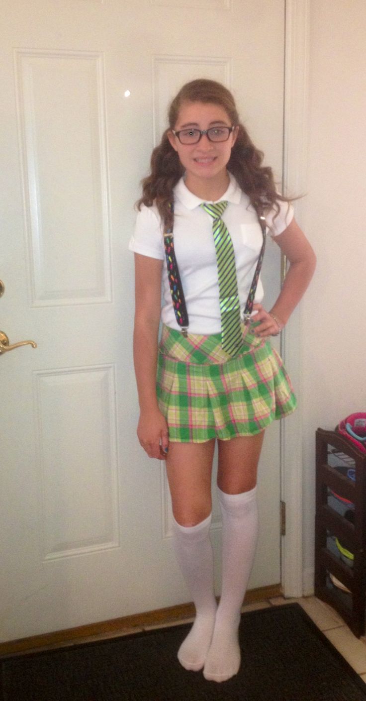 a girl in a skirt and tie posing for the camera