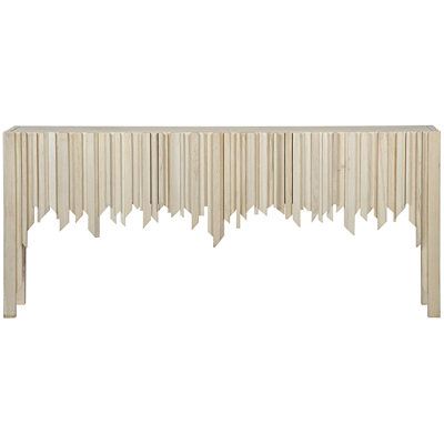 a white console table with long fringes on the top and bottom, against a white background