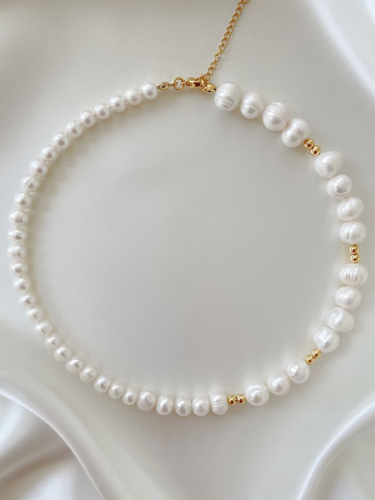 So simple, so clean. Make your choker dreams come true with this stunning pearl piece. Featuring 14K gold beads hand strung alongside genuine freshwater pearls, the 'CAPRI' necklace will have all eyes on you. Wear on its own, or stack with our 'FAI' chain to instantly dress up any look! Made with 14K gold filled beads and genuine AAA-grade freshwater pearls. Available in lengths 14", 15", 16", 18", 20". All lengths include a 2" extension chain. Model is wearing 16". Handmade in Los Angeles. Pearl Beach, Pearl Necklace Designs, Beach Necklaces, Jewelry Accessories Ideas, Gold Bead Necklace, Gold Pearl Necklace, Bead Work Jewelry, Handmade Ideas, Freshwater Pearl Necklace