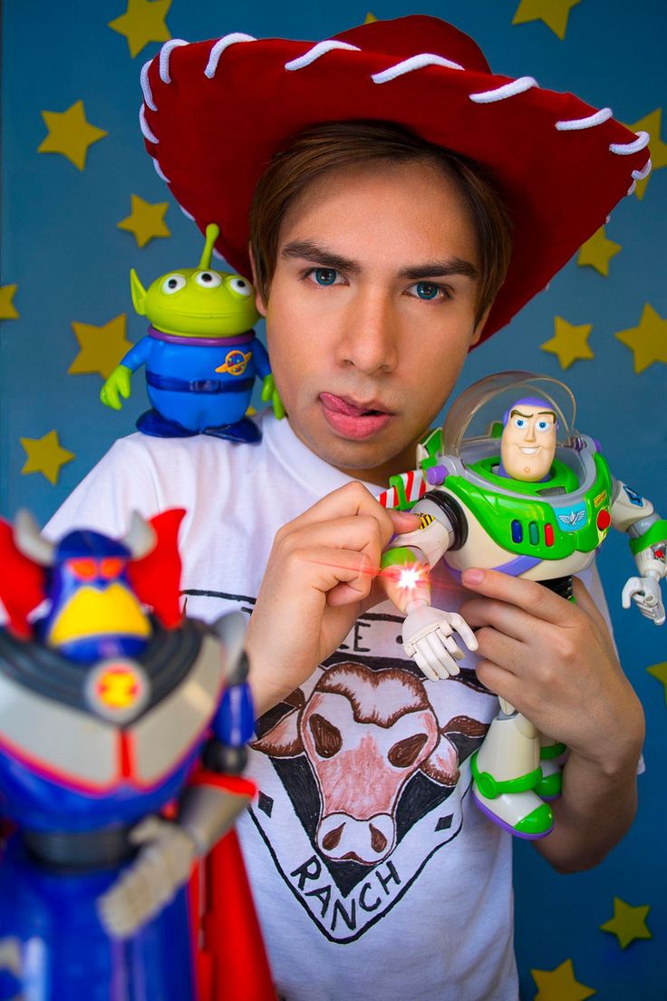 a young man in a red hat holding toy figures