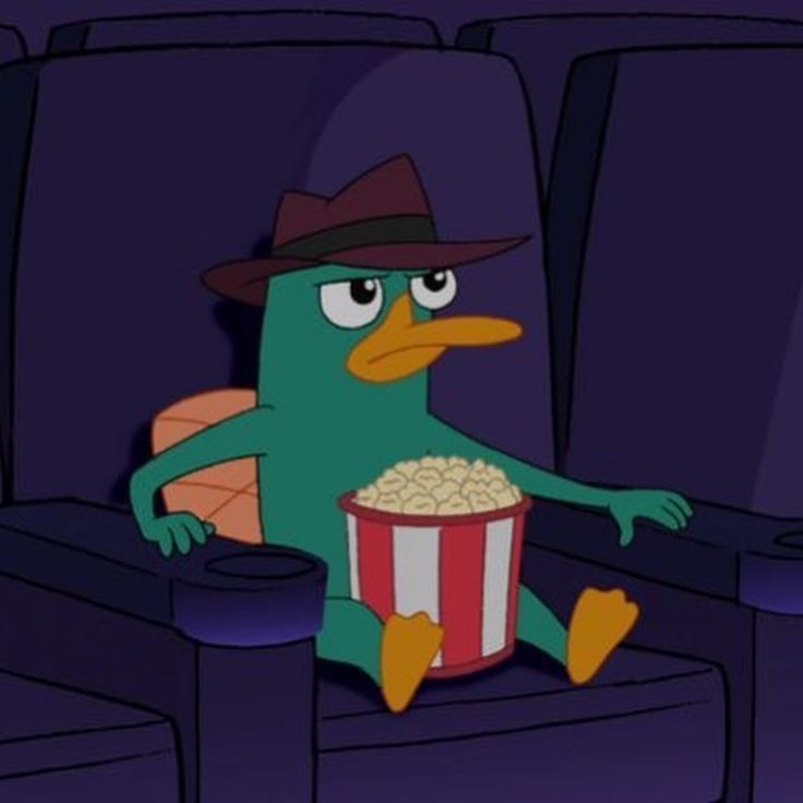 a green bird with a hat and glasses sitting in a movie theater holding a popcorn bucket