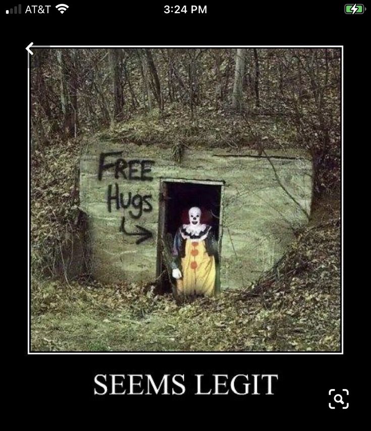 there is a creepy clown in the door of a building that says free hugs, seems legit