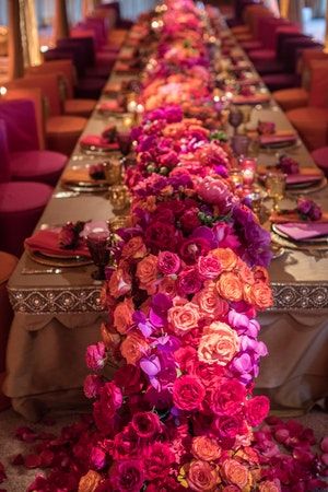 the long table is decorated with flowers and candles