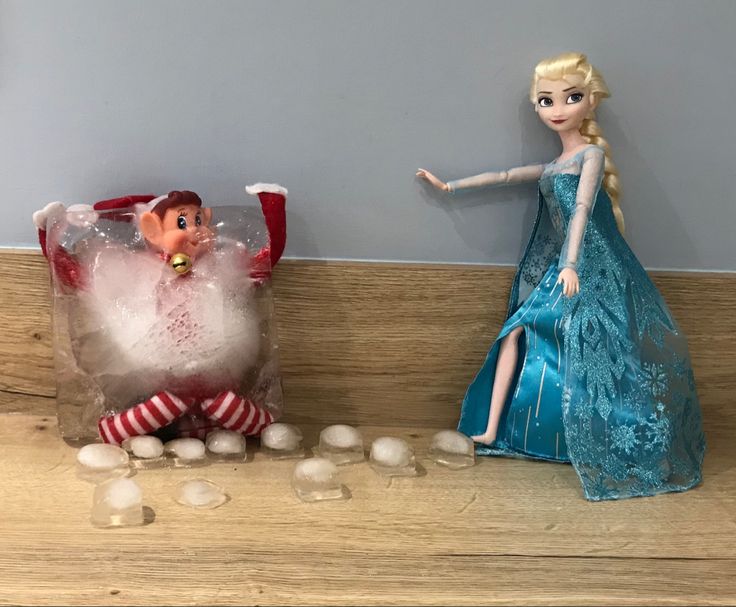 there is a frozen queen and santa clause on the shelf