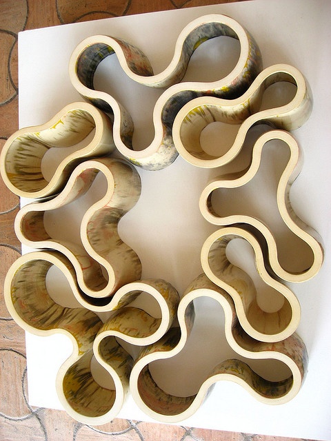 an art piece made out of wood with wavy shapes