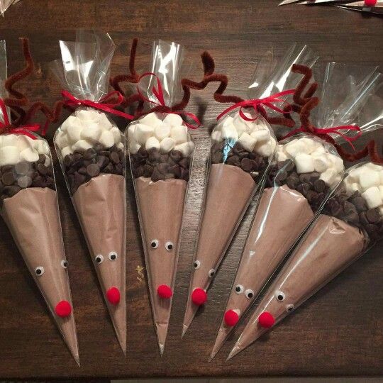 six chocolate cones wrapped in cellophane and decorated with reindeer noses, white marshmallows, and candy canes