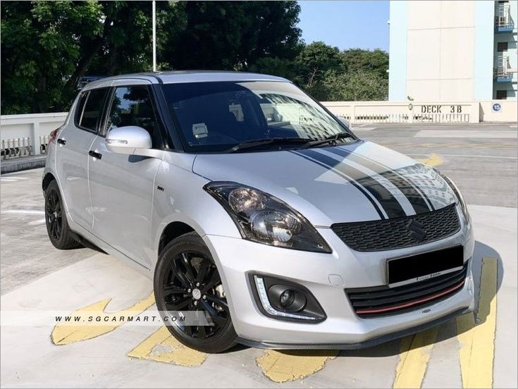 a silver and black car is parked in the parking lot