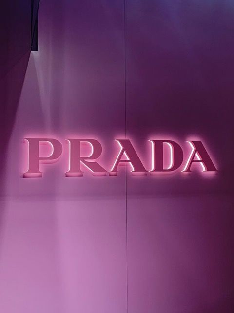 the word prada is lit up in pink