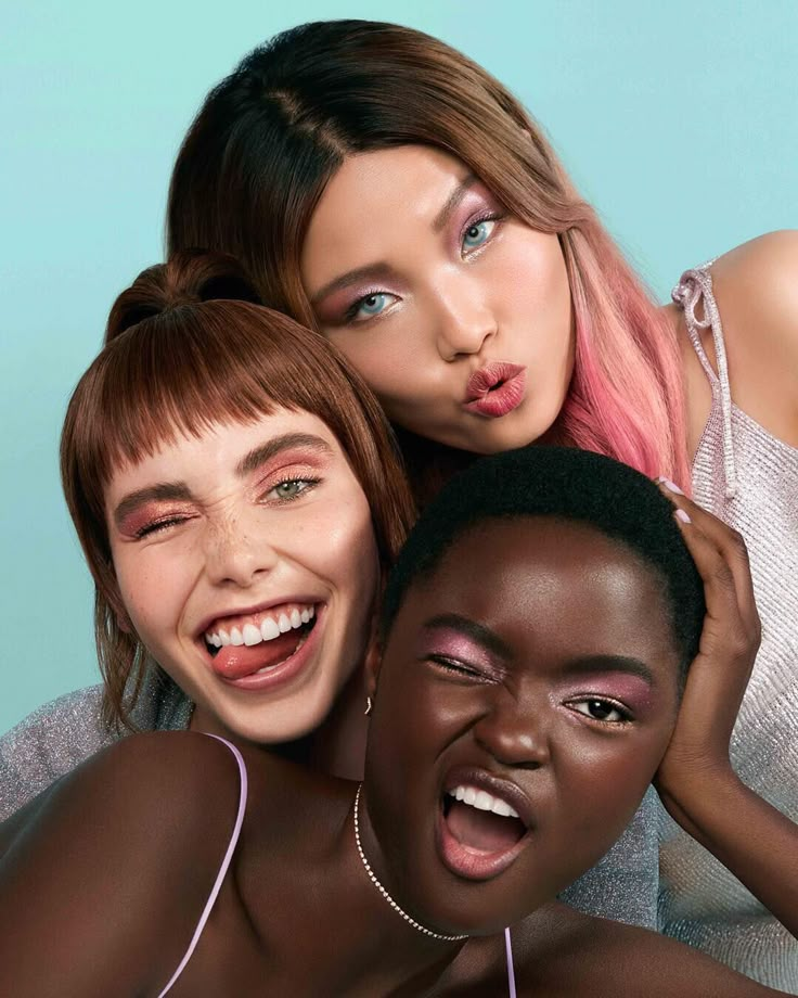 three women posing for the camera with their mouths open and one woman sticking her tongue out