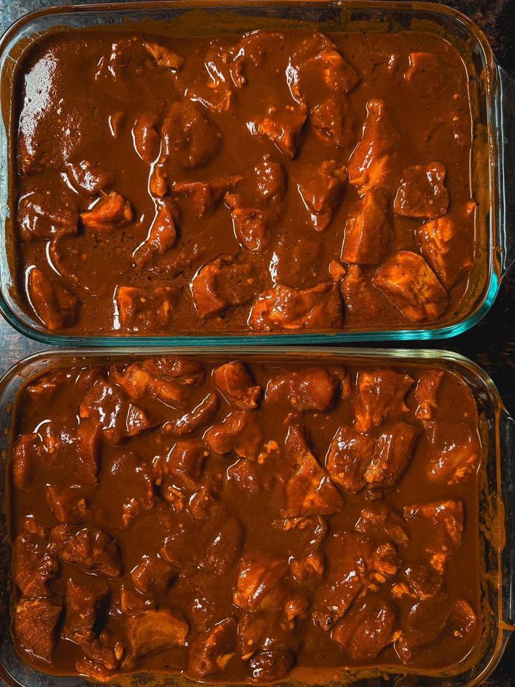 two pans filled with meat covered in sauce