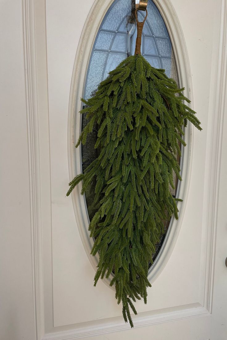 a wreath is hanging on the front door