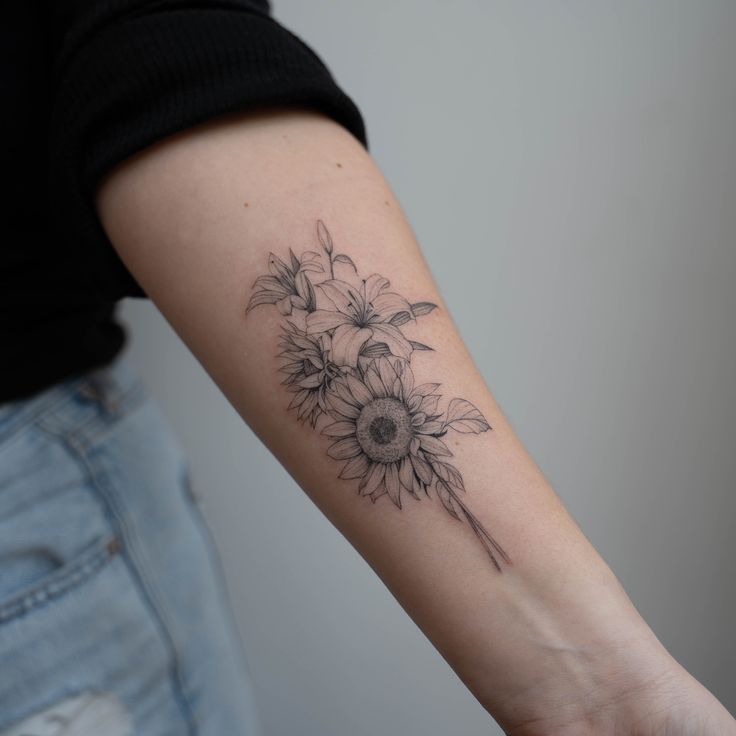 a woman's arm with a sunflower tattoo on it